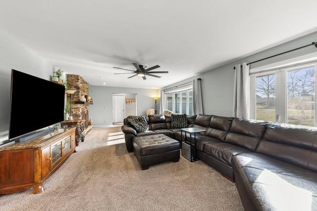 carpeted living room with ceiling fan