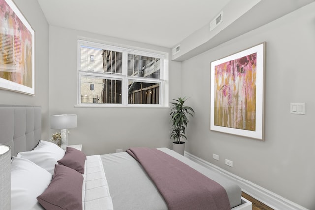 bedroom with wood-type flooring