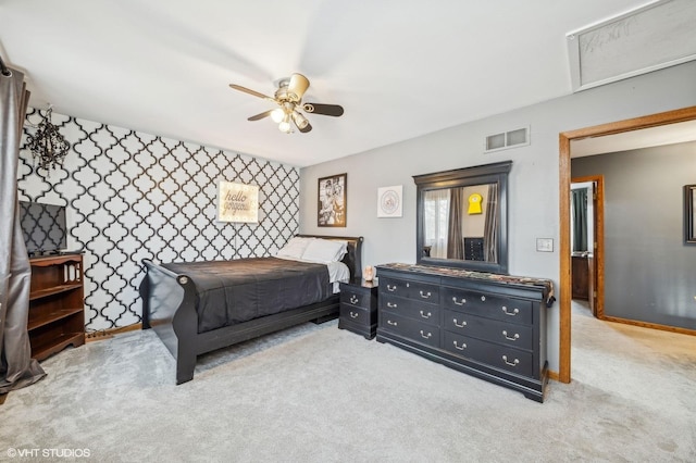 bedroom with visible vents, a ceiling fan, light carpet, baseboards, and wallpapered walls