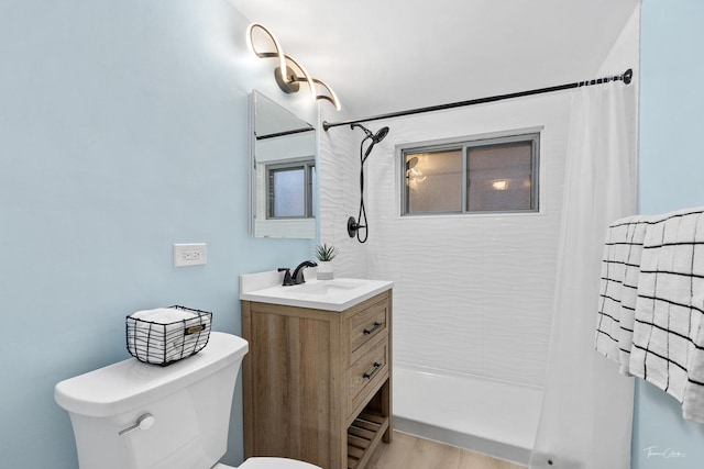 bathroom featuring curtained shower, hardwood / wood-style floors, vanity, and toilet