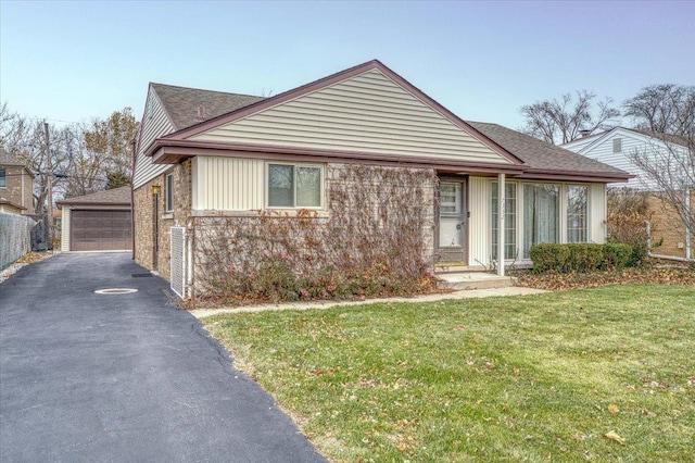 view of front of property with a garage and a front lawn