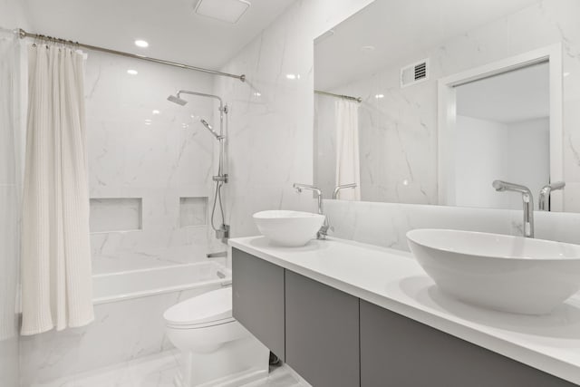 full bathroom with vanity, shower / bath combo, and toilet