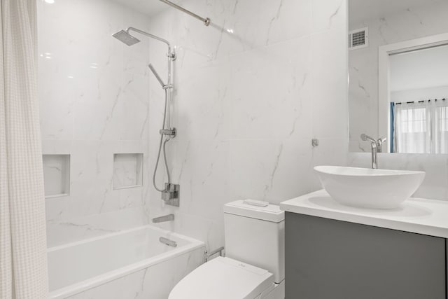 bathroom with shower / tub combo, vanity, and tile walls