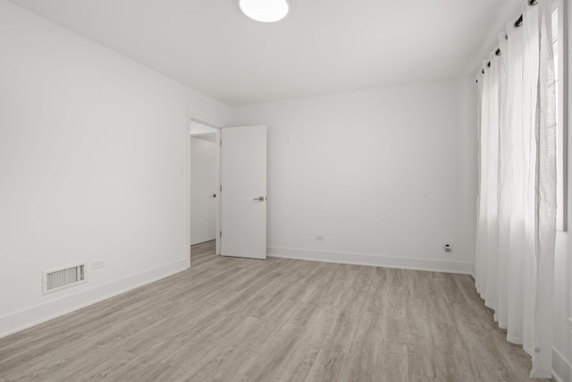 unfurnished room with light hardwood / wood-style floors