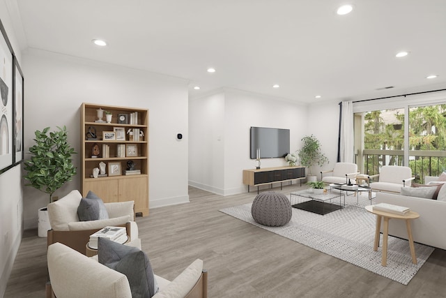 living room with wood-type flooring and crown molding