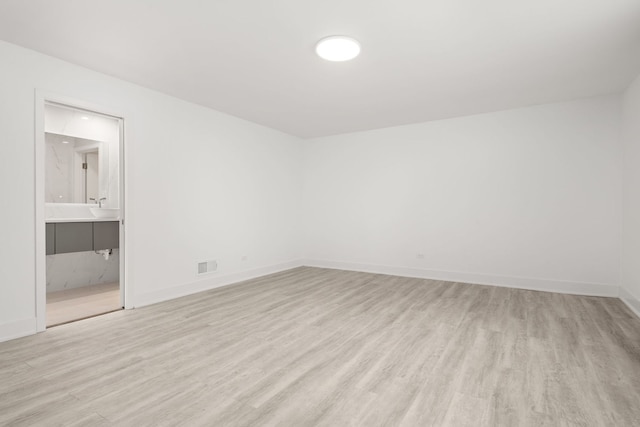 spare room with light hardwood / wood-style flooring