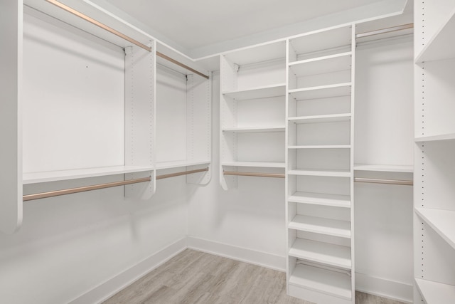 walk in closet featuring light hardwood / wood-style flooring