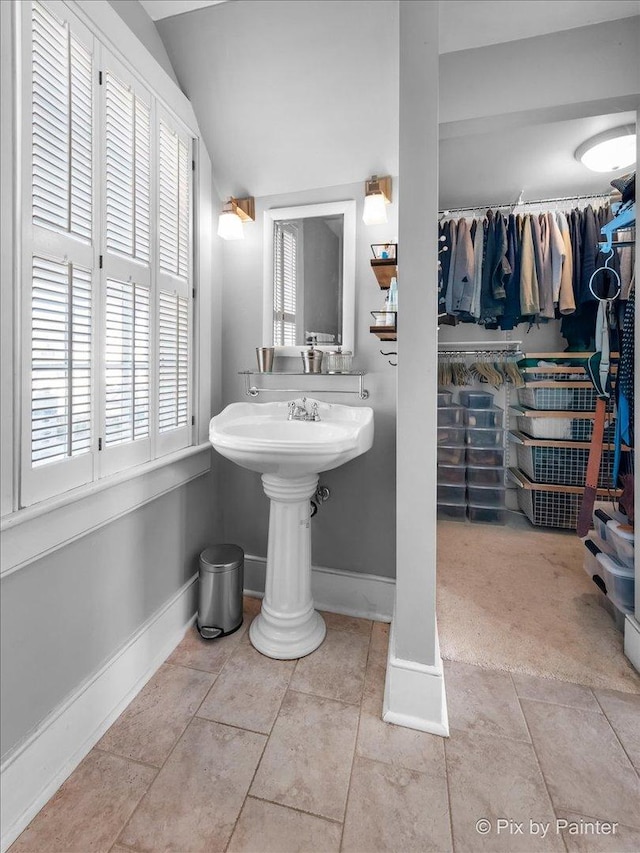 bathroom featuring tile patterned floors and vaulted ceiling