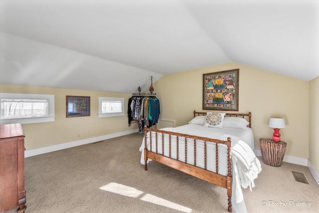 carpeted bedroom featuring vaulted ceiling