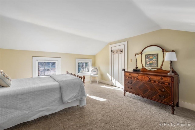 bedroom featuring carpet flooring and lofted ceiling