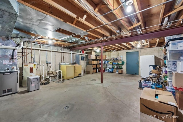 basement featuring separate washer and dryer, water heater, and heating unit