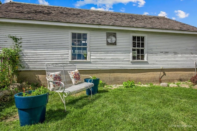 rear view of house with a yard