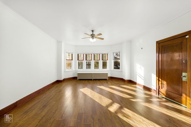 unfurnished living room with radiator, ceiling fan, dark hardwood / wood-style flooring, and ornamental molding