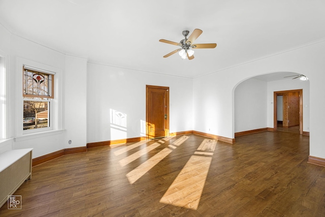 spare room with radiator, ceiling fan, and dark hardwood / wood-style flooring