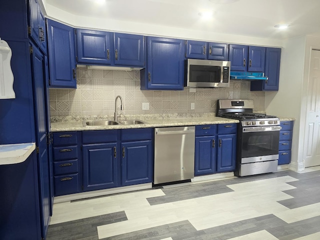 kitchen with blue cabinetry, sink, and stainless steel appliances