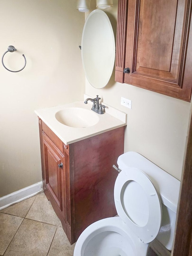 bathroom featuring tile patterned flooring, vanity, and toilet