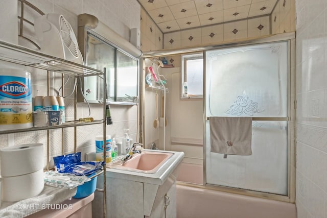 bathroom featuring vanity and bath / shower combo with glass door