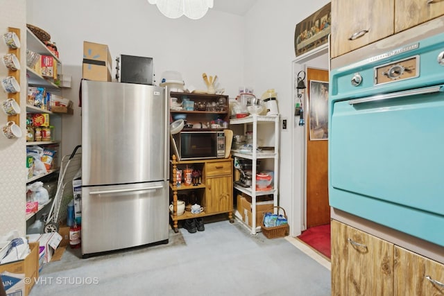 kitchen with stainless steel fridge and white oven