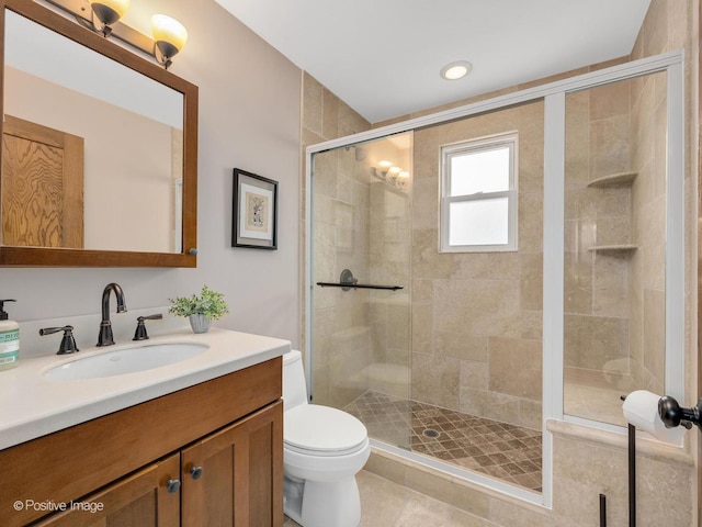 bathroom with toilet, an enclosed shower, vanity, and tile patterned flooring