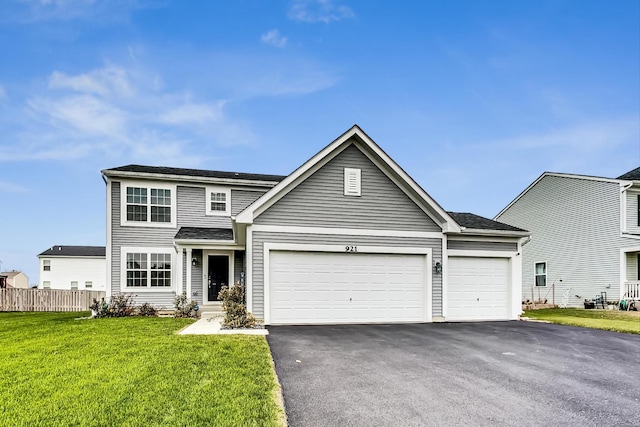 view of front facade with a front yard and a garage