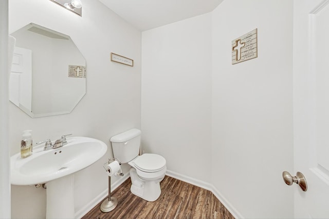 bathroom featuring hardwood / wood-style flooring, toilet, and sink