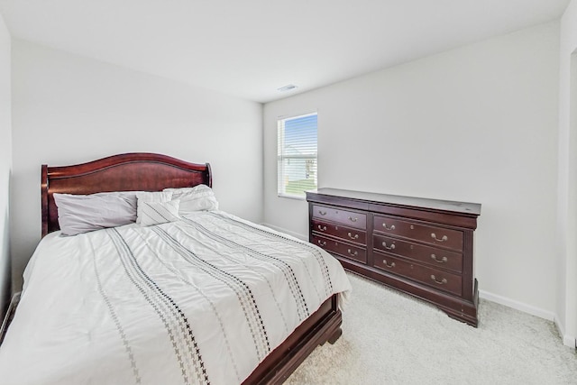 bedroom with light colored carpet