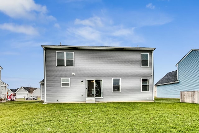 back of house with a lawn