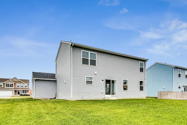 rear view of property with a yard