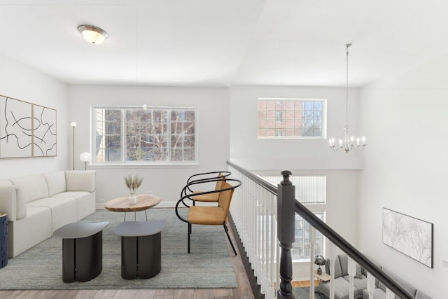 living room featuring a notable chandelier, a wealth of natural light, and hardwood / wood-style floors