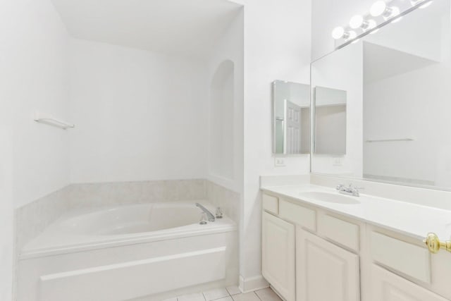 bathroom featuring tile patterned flooring, a bath, and vanity