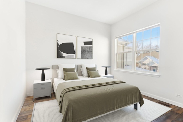 bedroom with dark hardwood / wood-style floors