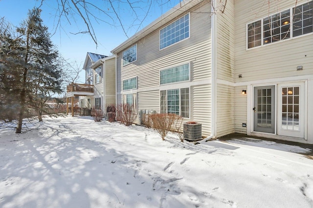 snow covered property featuring central air condition unit