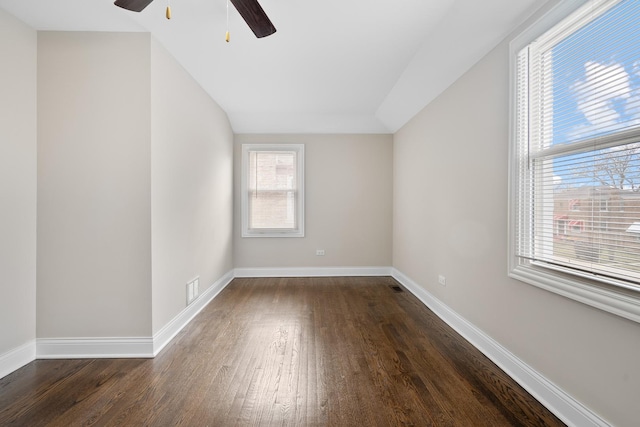 empty room featuring dark hardwood / wood-style flooring, plenty of natural light, lofted ceiling, and ceiling fan