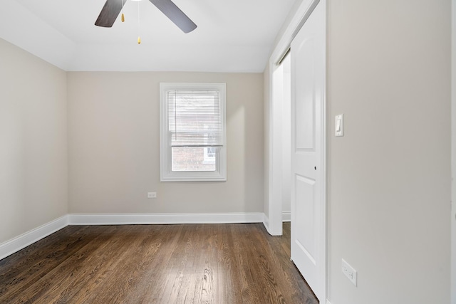 unfurnished bedroom with ceiling fan, a closet, and dark hardwood / wood-style floors