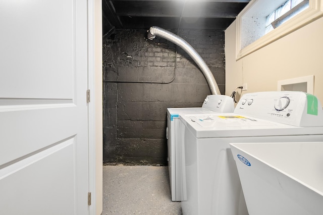 washroom with washer and clothes dryer and sink