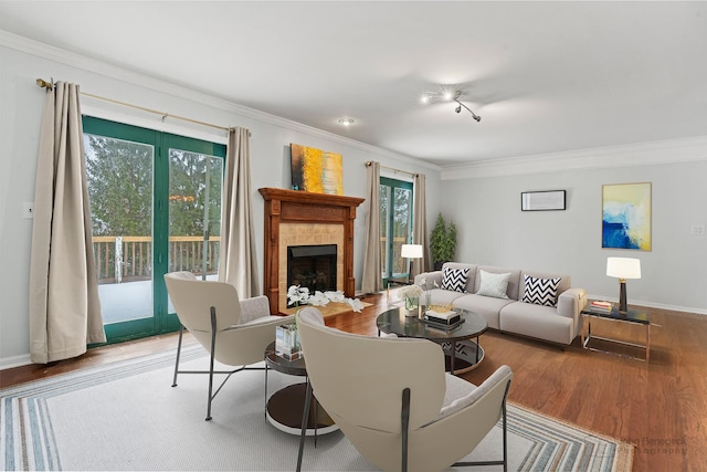 living room with a fireplace, light wood-type flooring, and crown molding