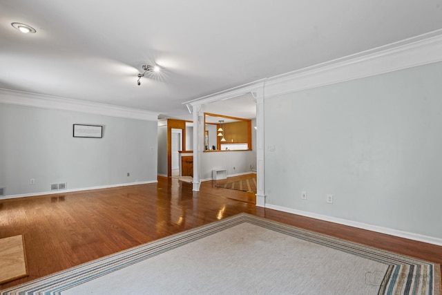 empty room with hardwood / wood-style floors and ornamental molding