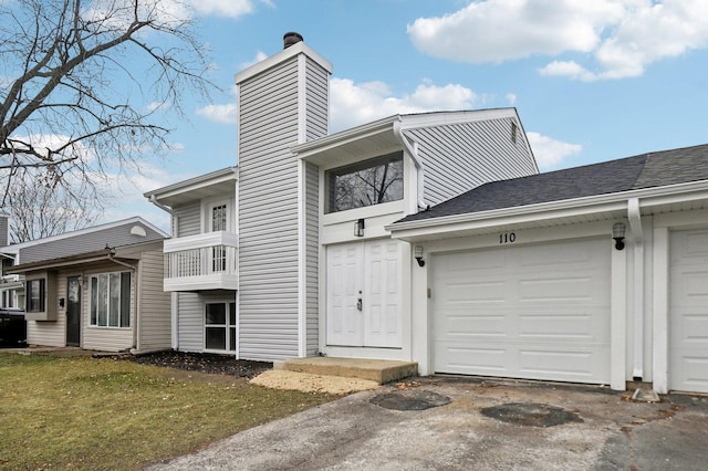 exterior space with a front yard and a garage