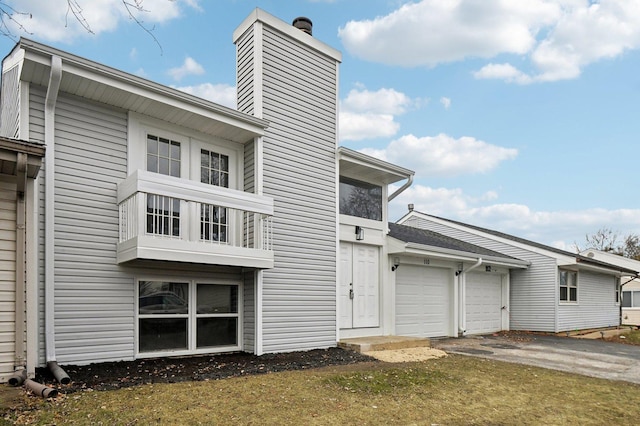 rear view of house with a yard and a garage