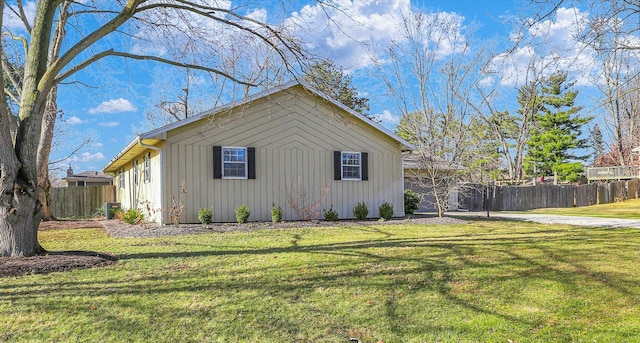 view of property exterior with central air condition unit and a yard