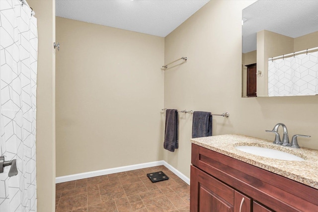 bathroom featuring vanity and a textured ceiling