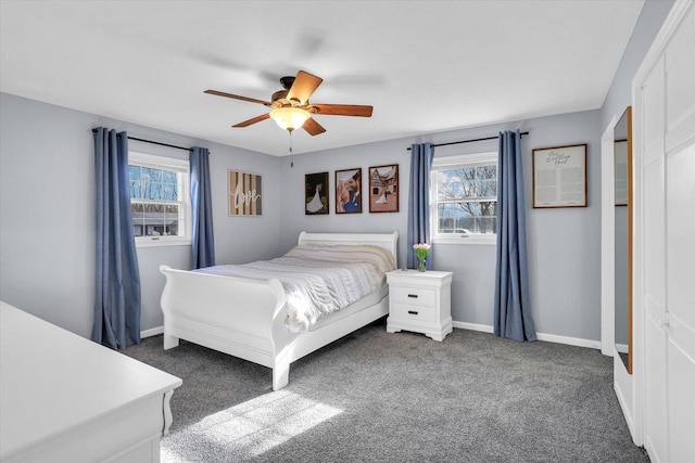 carpeted bedroom with multiple windows and ceiling fan