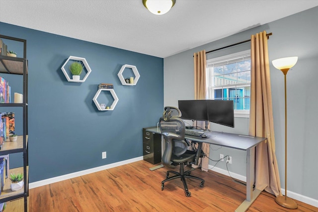 office featuring hardwood / wood-style floors and a textured ceiling