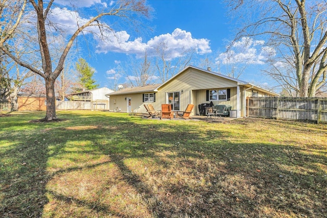 rear view of house featuring a yard