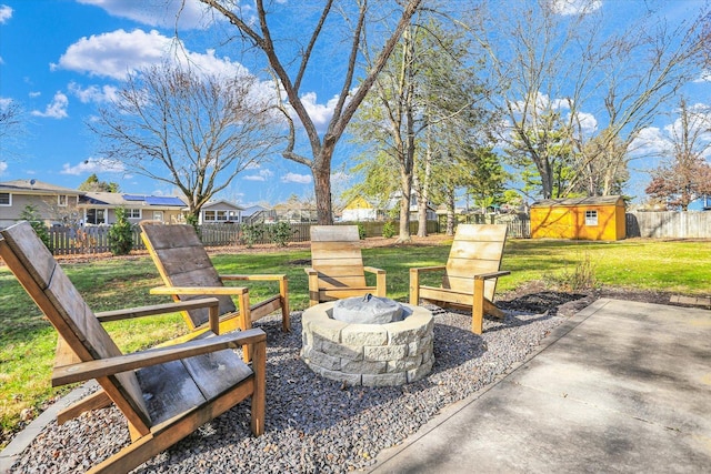 view of yard featuring a patio, a shed, and an outdoor fire pit