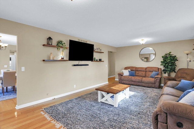 living room featuring hardwood / wood-style flooring and a notable chandelier