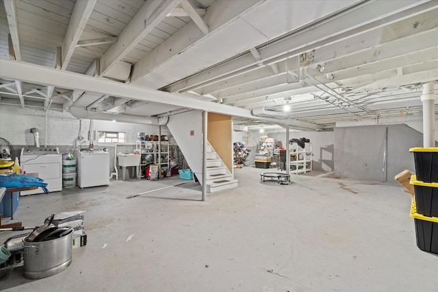 basement featuring separate washer and dryer and sink