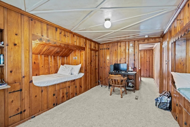 office area with wood walls and light colored carpet