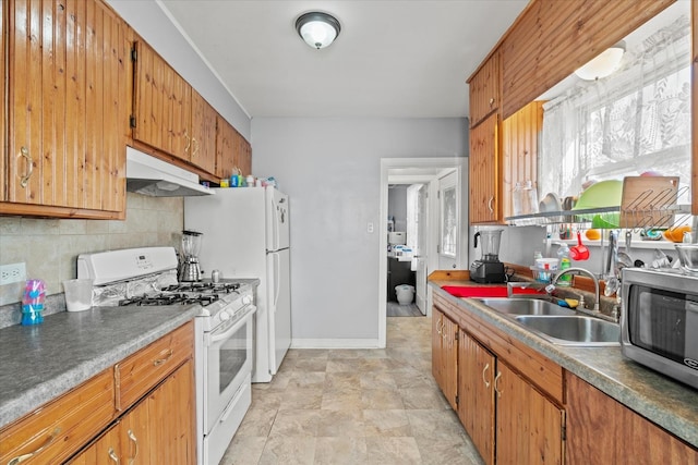 kitchen with tasteful backsplash, white gas range, and sink