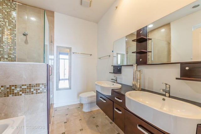 full bathroom featuring tile patterned flooring, vanity, toilet, and shower with separate bathtub